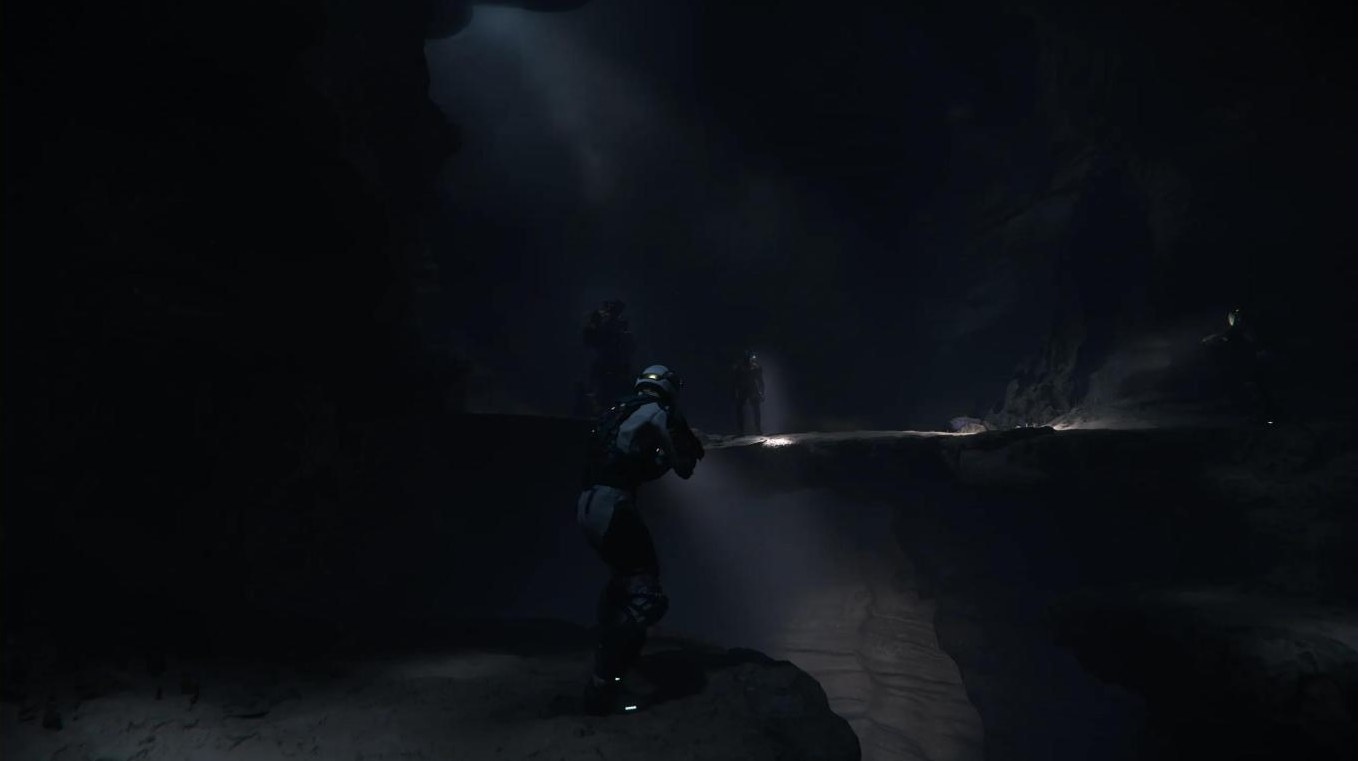 Explorers with flashlights inside a dark cave