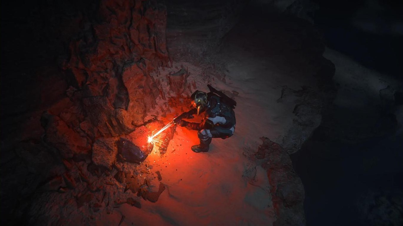 Miner working by red flarelight in a cave