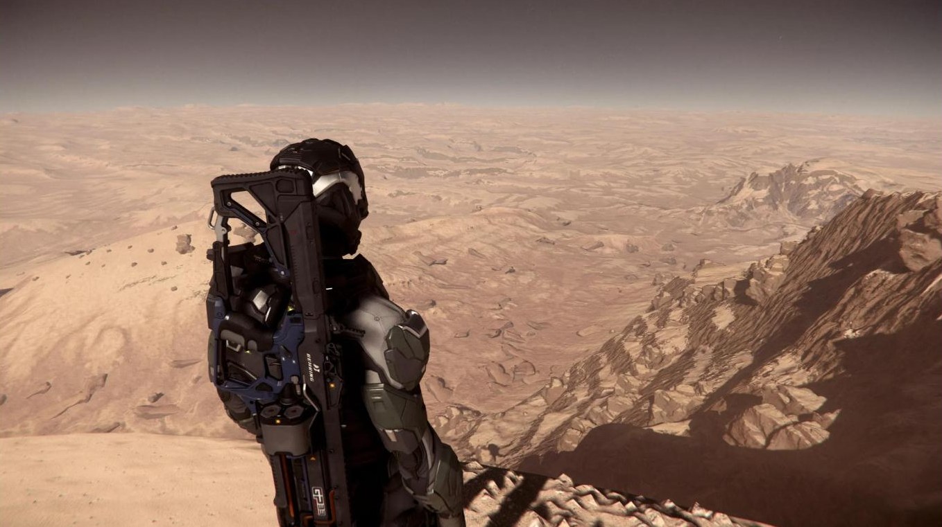 Armored figure standing on a desert peak